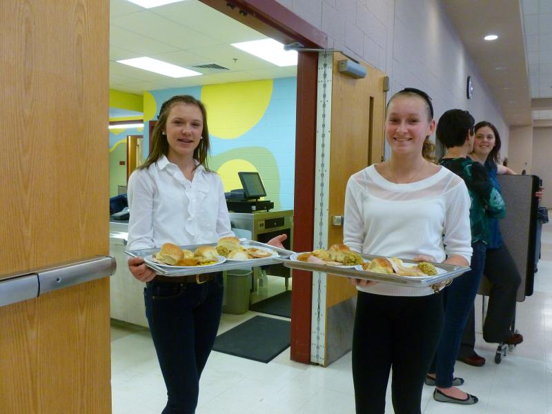Junior High students Sydney Hughes, left, and Maxine Kellum prepare to serve seniors a Thanksgiving dinner on Sunday, Nov. 24. BY JULIA NOJEIM